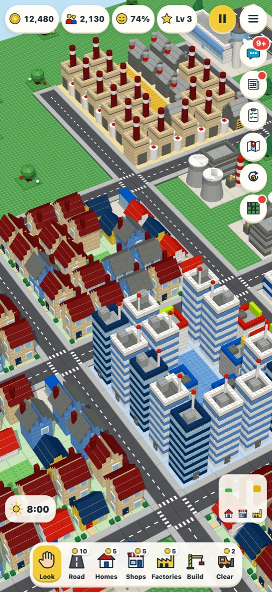 A busy brick town with houses, tower blocks and factories.